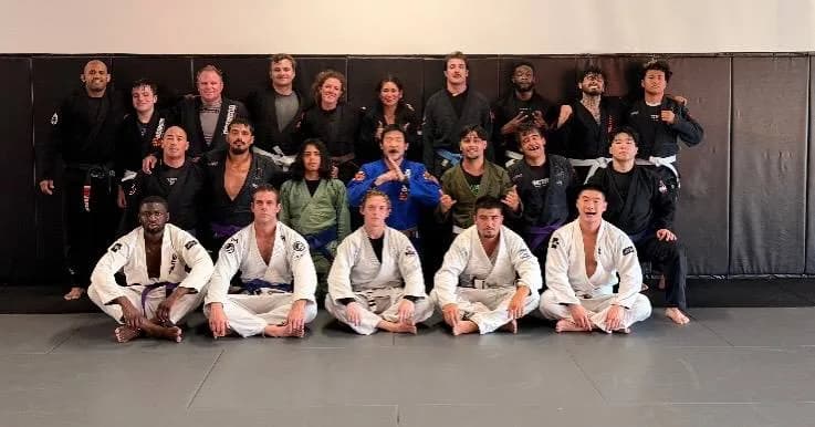 Ben with his Brazilian jiu-jitsu class, everyone in gis on the mats