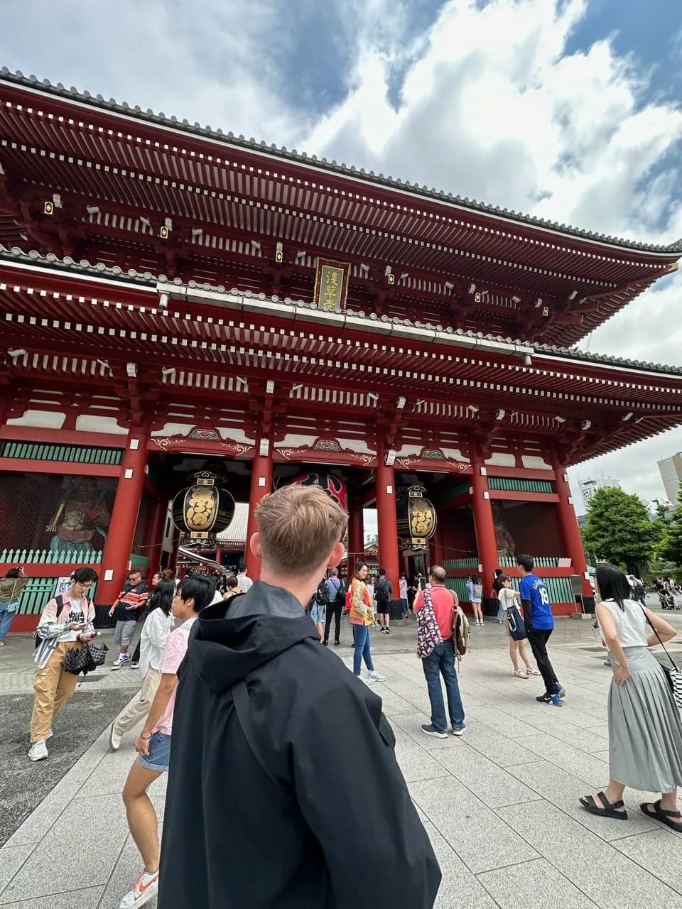 Ben looking up at the red Sensō-ji temple gate in Tokyo